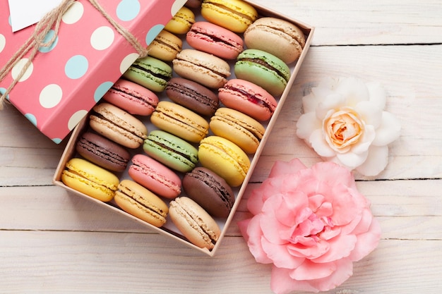 Colorful macaroons in a gift box and roses