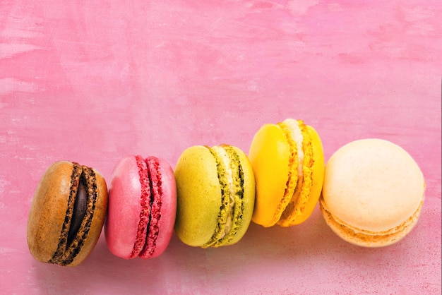 Colorful macaroons on pink background