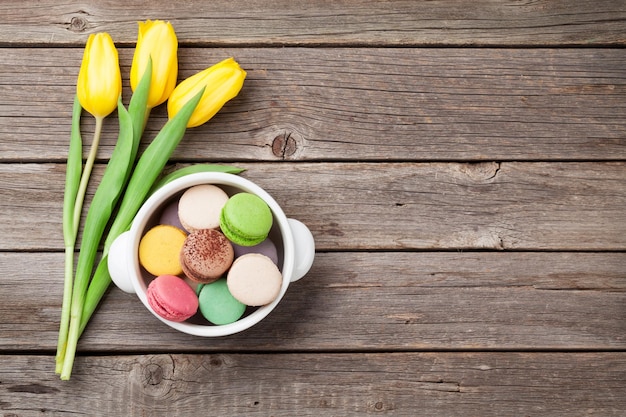 Colorful macaroons and yellow tulips