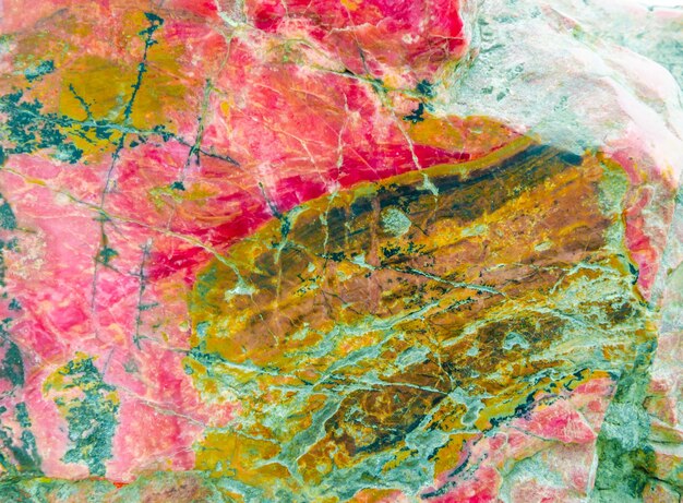 Photo a colorful marble with a pink and yellow marble background.