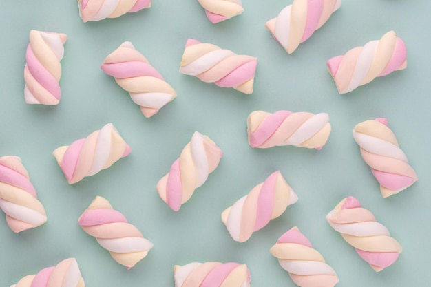 Colorful marshmallow laid out on pastel background. Creative textured pattern.