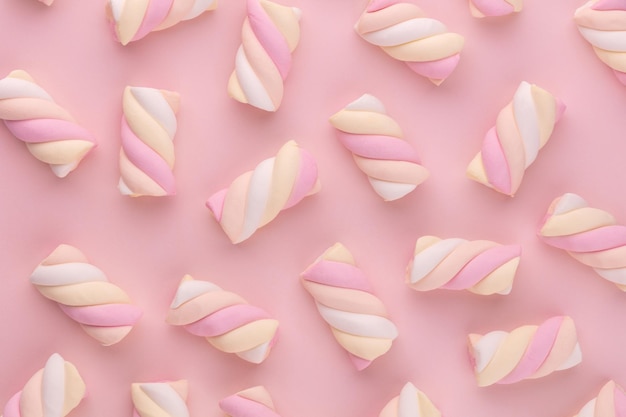 Colorful marshmallow laid out on pastel background. Creative textured pattern.