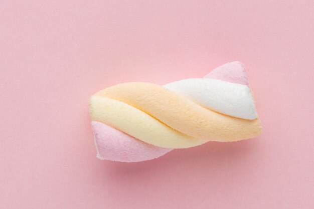 Colorful marshmallows on pastel background.