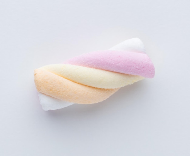 Colorful marshmallows on pastel background