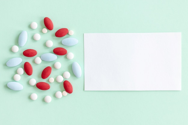 Colorful medical pills and tablets design concept of healthcare and medicine with a white paper note.