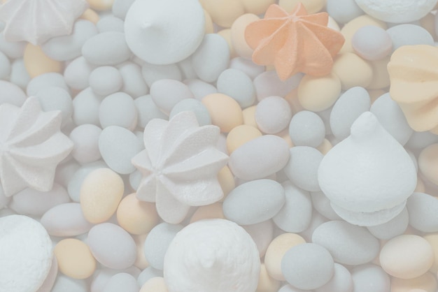 Colorful meringues and glazed peanuts isolated on a white background