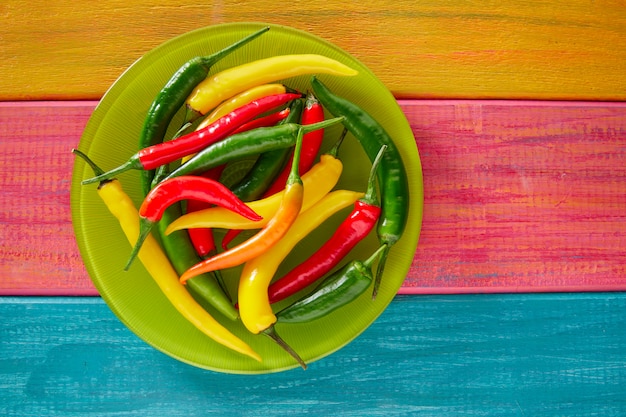 Colorful mexican chili peppers in wood table