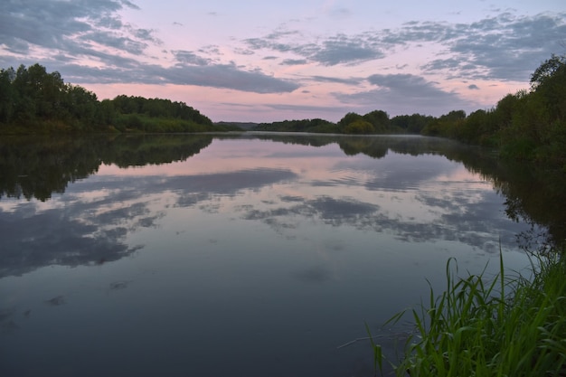 Colorful and misty dawn over a small river