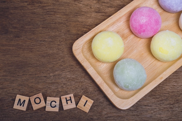 The colorful mochi dessert ice cream on wood plate ,Close Up photo with selective focus.