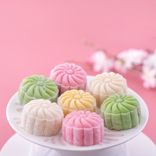 Colorful moon cake for Mid-Autumn Festival on pink background