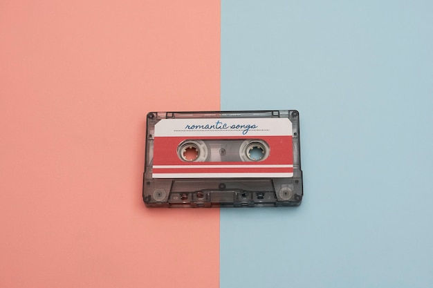 Colorful music cassette on pink and light blue background