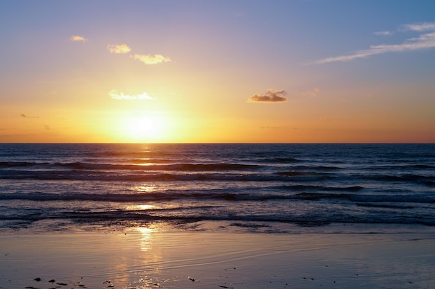 Colorful ocean beach sunset with deep clouded sky Beautiful cloud over the sea during sunset