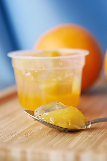 Colorful orange flavor jelly on plate on table