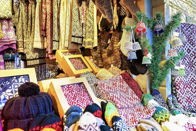 Colorful and ornamental socks, scarfs, mittens and hats at one of the stalls during the Christmas Market in Riga, Latvia. The market is a part of the traditional celebrations during Christmas period.