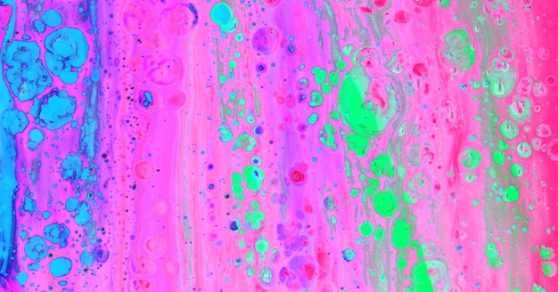 A colorful painting with pink and green paint splatters.