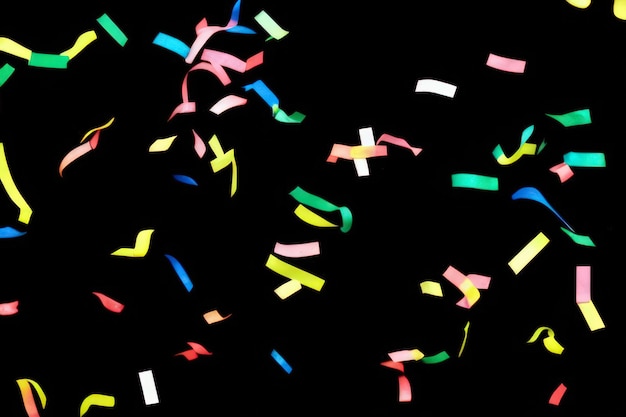 Colorful paper confetti on black background