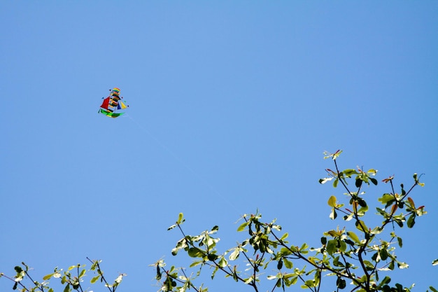 Colorful paper kite in the form of a ship flying in the sky He has a rope