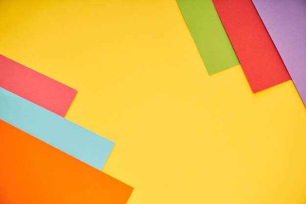 Colorful papers on yellow background