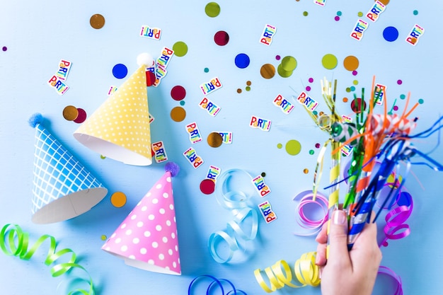 Colorful party hats for kids Birthday Party on blue background.