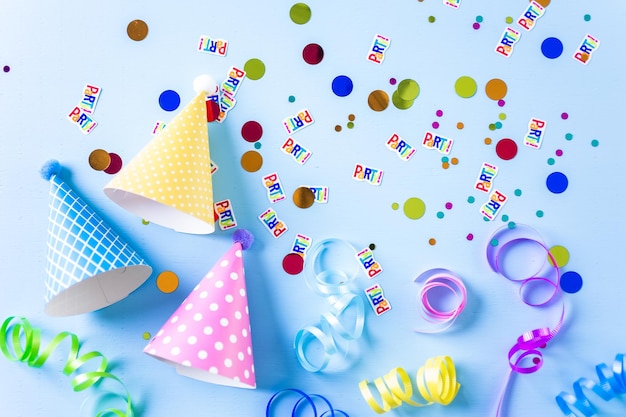 Colorful party hats for kids Birthday Party on blue background.