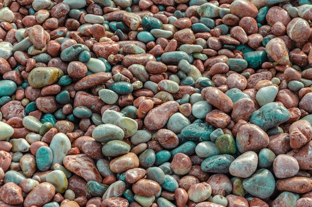 Colorful pebbles on the beach near the sea.