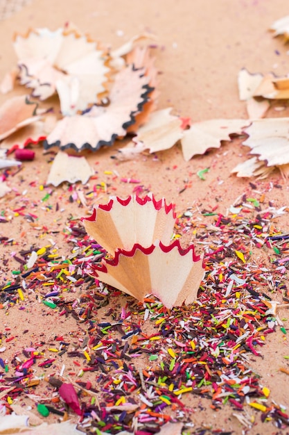 Colorful pencil shavings on brown background