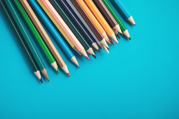 Colorful pencils on the blue table