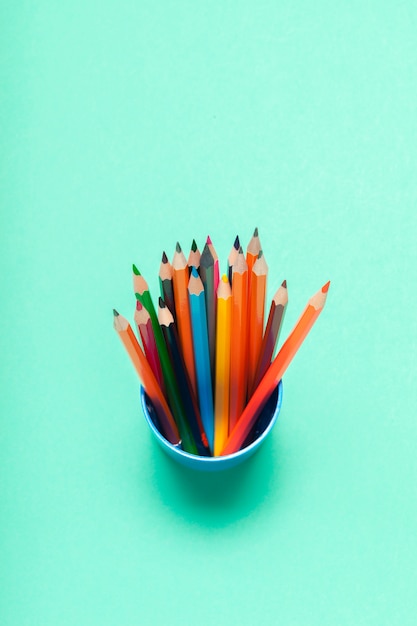 Colorful pencils in a cup top view