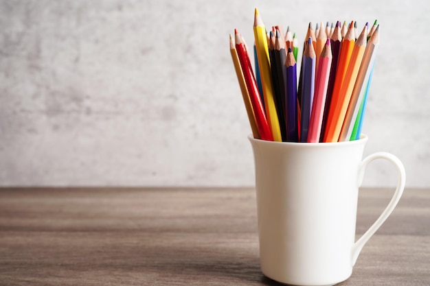 Colorful pencils in glass jar with copy space learning university education concept