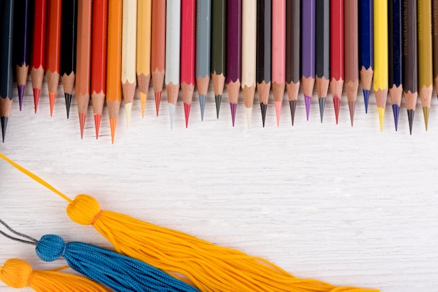 Colorful pencils lay on white wooden floor.