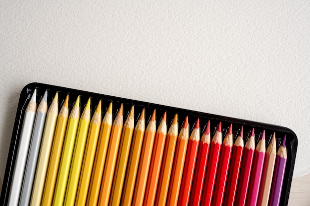 Colorful pencils set on watercolor paper