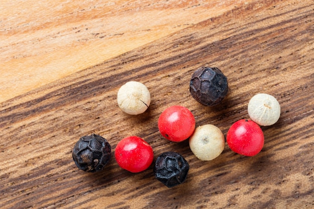 Colorful peppercorn on wooden background