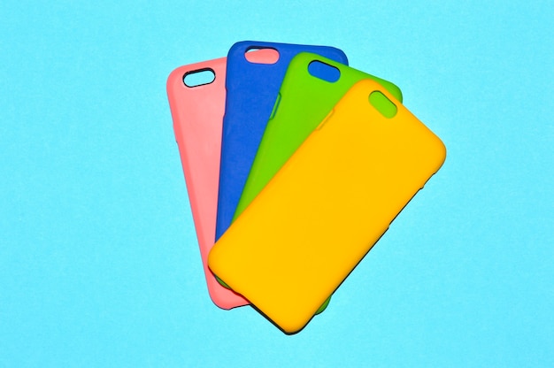 Photo colorful phone cases on blue background