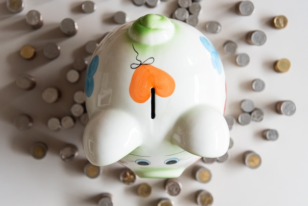 Colorful piggy bank and money tower