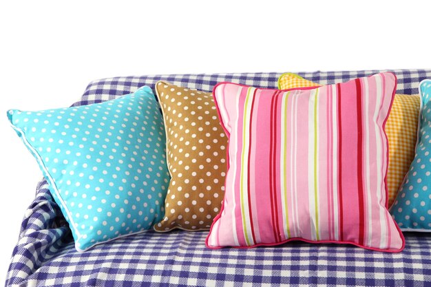 Colorful pillows on couch isolated on white