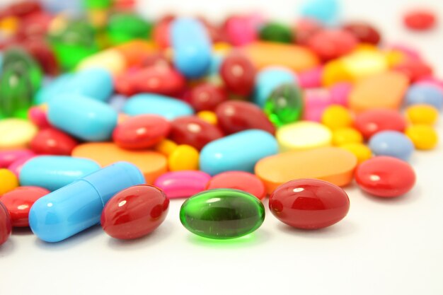 Colorful pills isolated on white surface