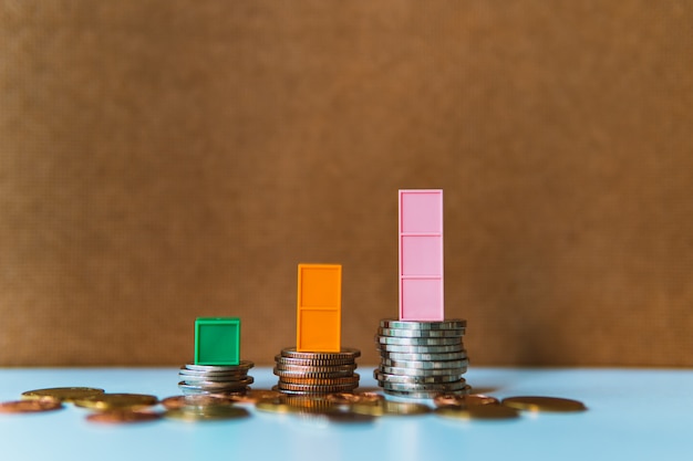 Colorful plastic graph on stack of coins