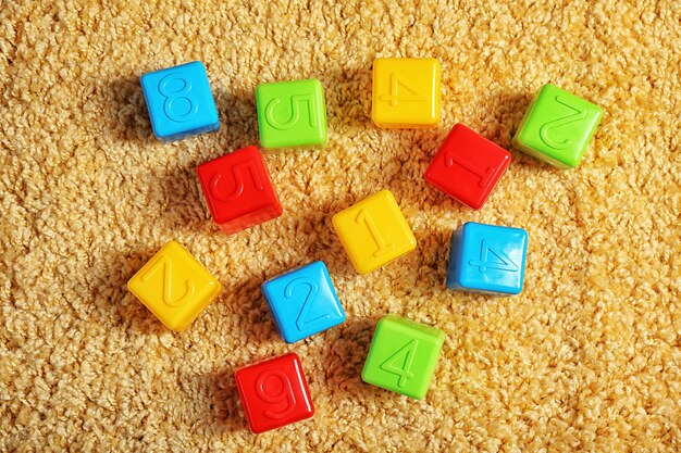 Colorful plastic kids toys on carpet