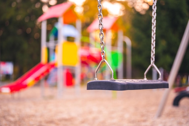 Colorful playground on yard in the park Colorful children playground activities in public park surrounded by green trees