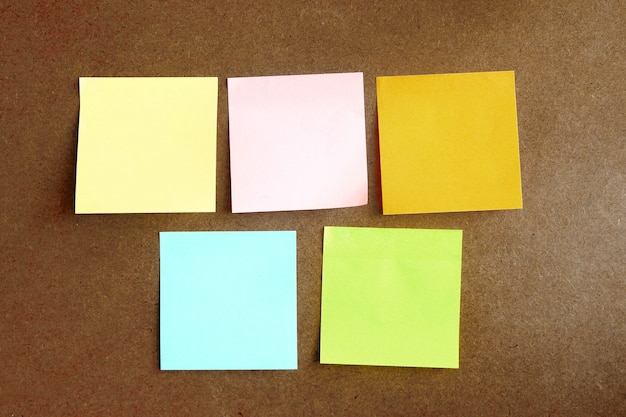 colorful post it paste on brown wood background have copy space