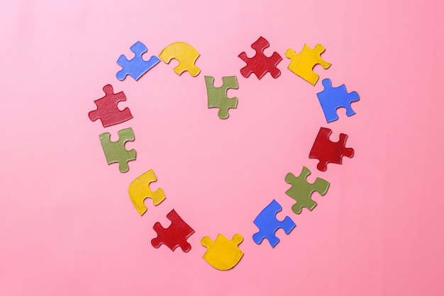 Colorful puzzle forming a heart shape. World Autism Awareness Day.