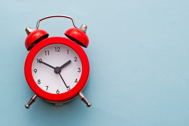 Colorful red traditional alarm clock with bells