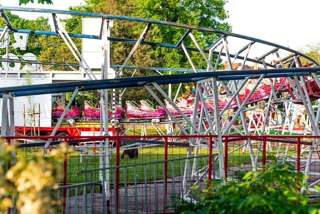 Colorful Roller coasters in amusement park at sunset