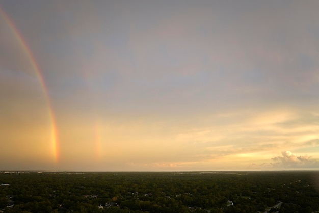 Colorful round rainbow against blue evening sky after heavy thunderstorm