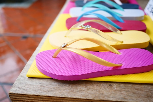 Colorful sandals on white background top down