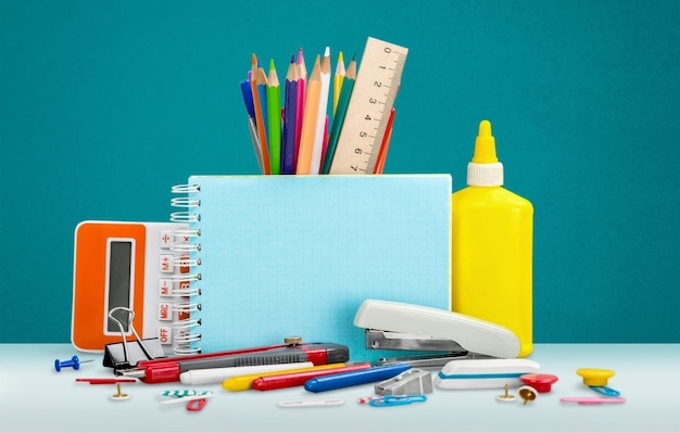 Colorful school supplies on  background