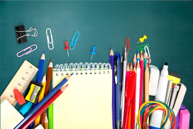 Colorful school supplies on wooden background