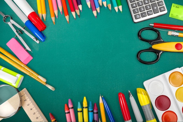 Colorful school supplies on wooden background