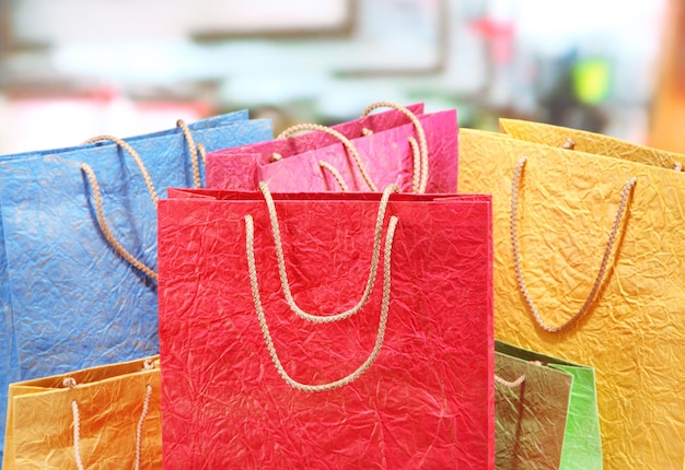 Colorful shopping bags on bright background