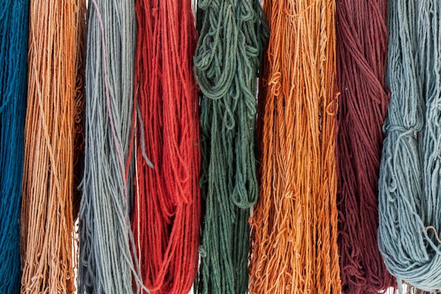 Colorful skeins of silk thread to create traditional Turkish carpet on a loom